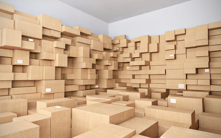Habitación repleta de cajas de cartón apiladas, creando una escena densa similar a la de un almacén.