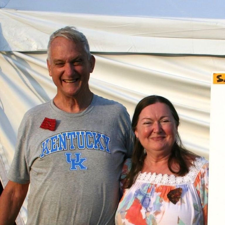 Photo of two storytellers standing outside a Cave Run Festival tent.