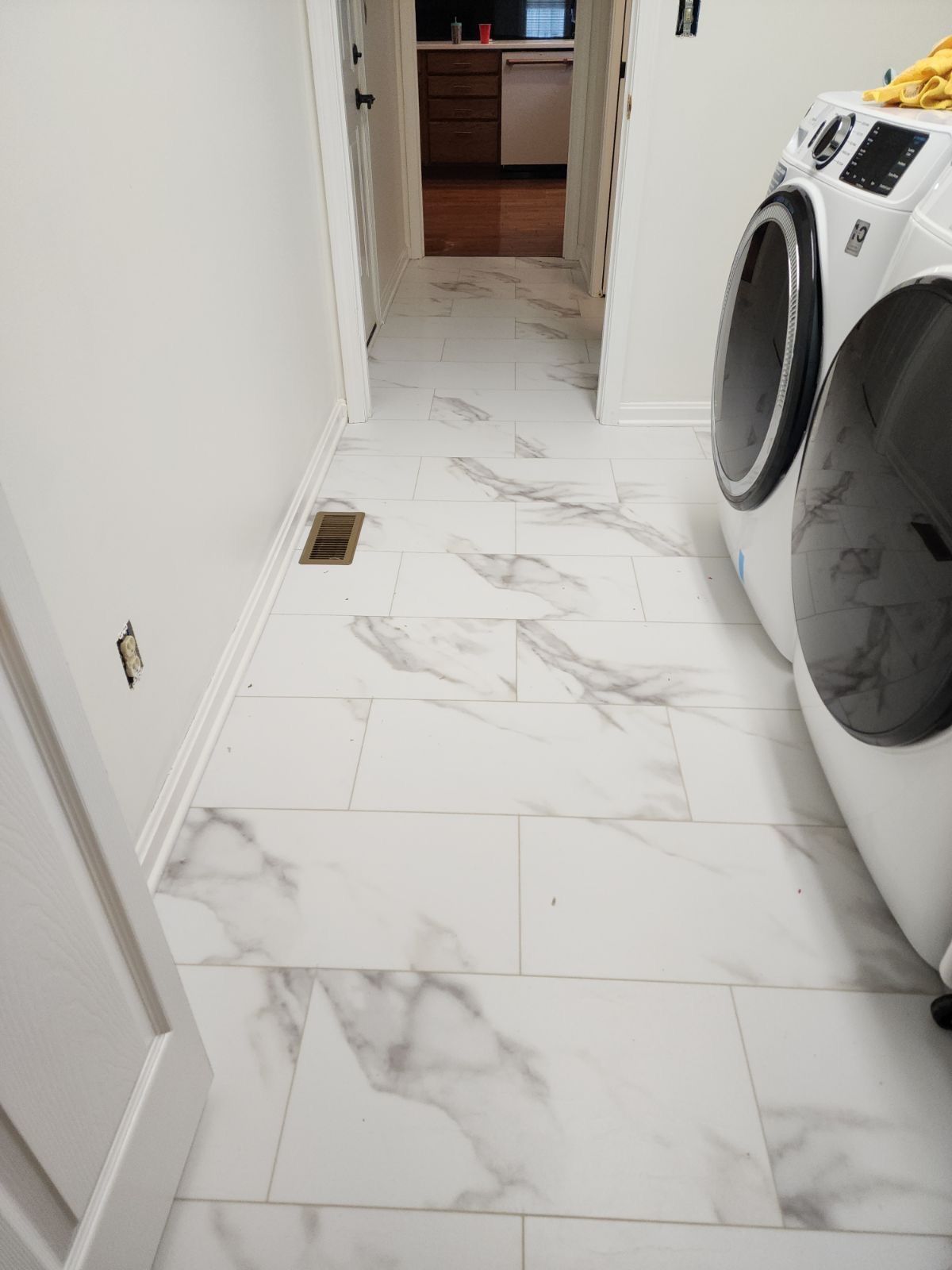 A laundry room with a washer and dryer on the floor.