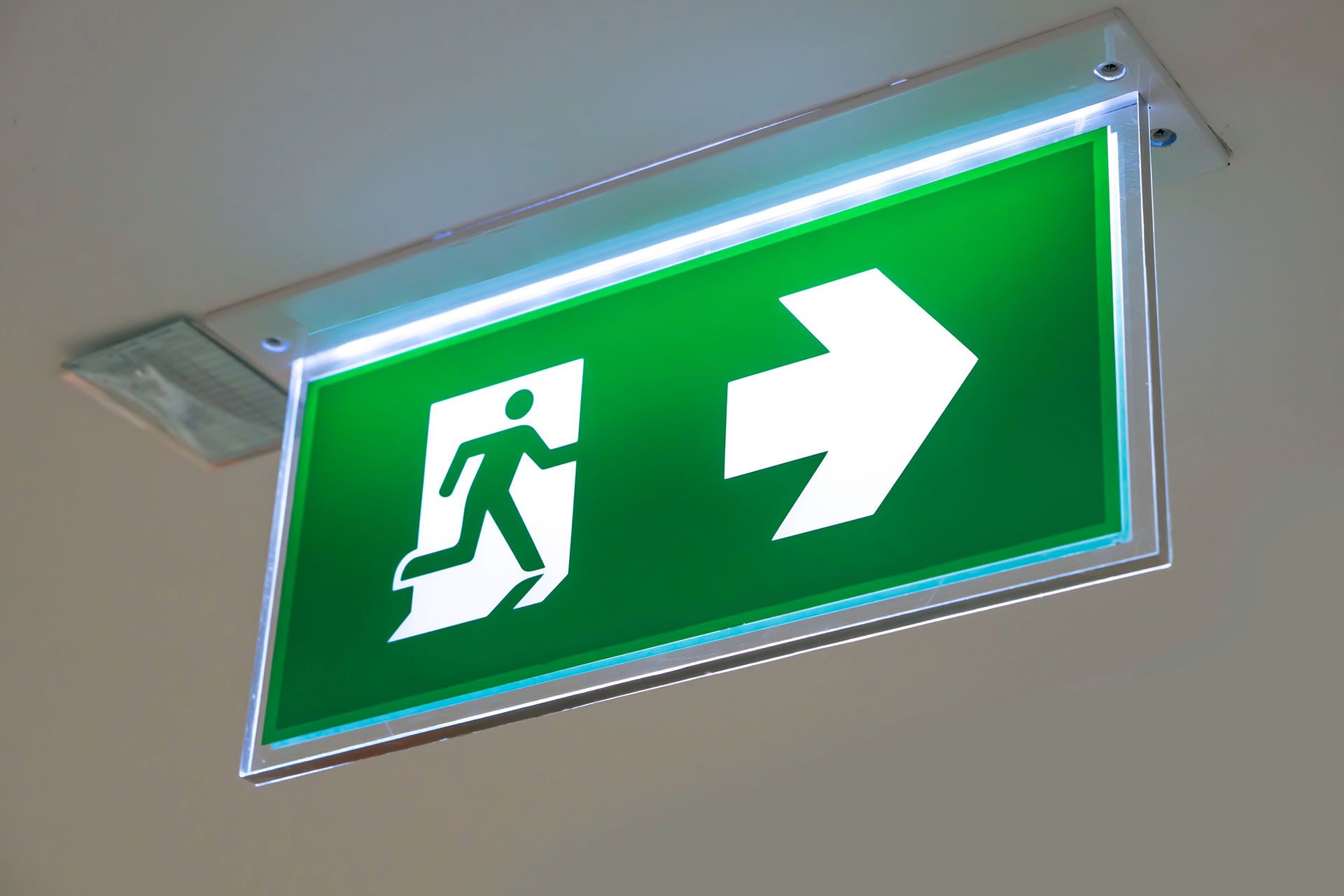 A green exit sign with an arrow pointing to the right