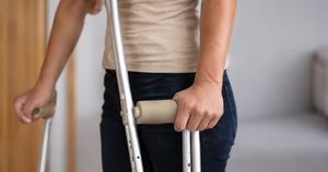 Person using crutches after suffering a personal injury