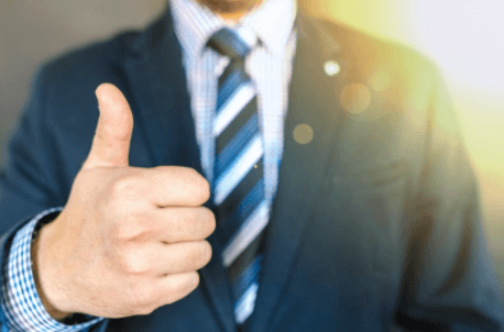 Close-up Photo of Man Wearing Black Suit Jacket Doing Thumbs Up Gesture