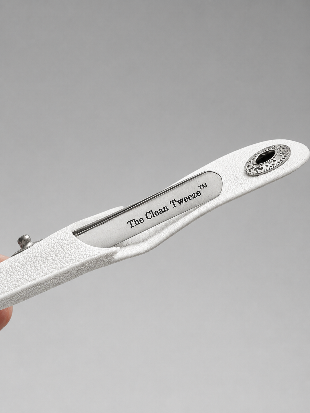 The Clean Tweeze™ slant tip tweezers in a white leather case for chin hair removal.