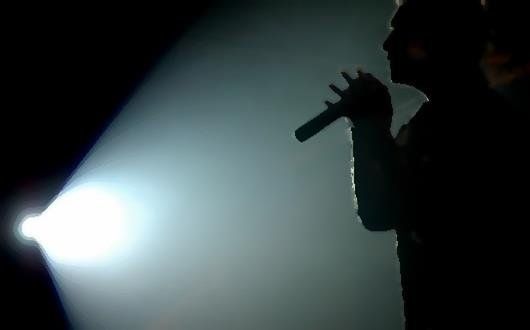 Man sings under spotlight
