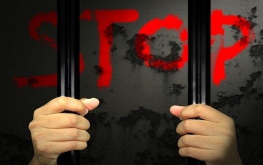 Hands on jail bars