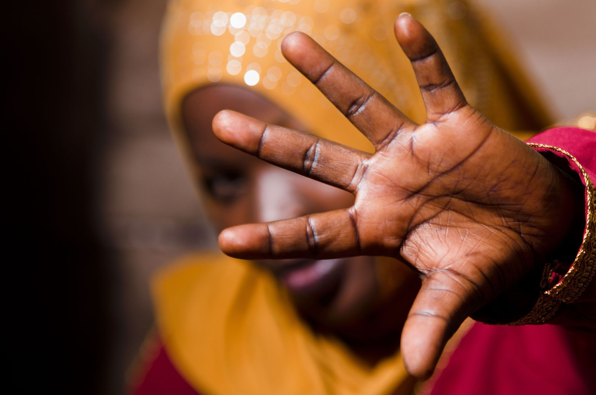Woman blocks face with her hands