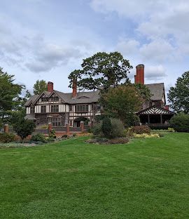 A large house with a large lawn in front of it.