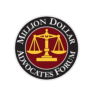 Million Dollar Advocates Forum logo with gold scales on a red and black circular emblem