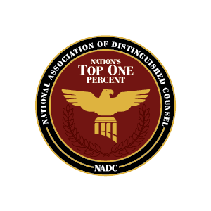 NADC seal with gold eagle on red background, reading “Nation’s Top One Percent” and “National Association of Distinguished Counsel.”
