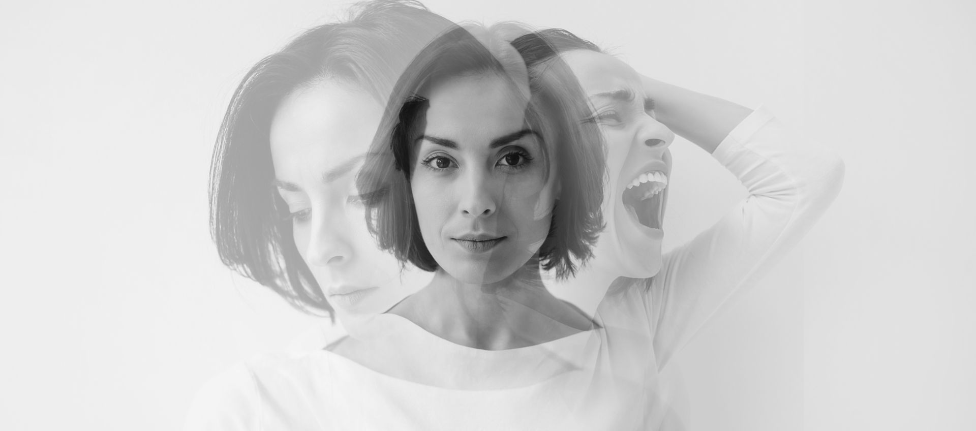 Grayscale portrait of a woman with layered double-exposure faces, one hand behind her head