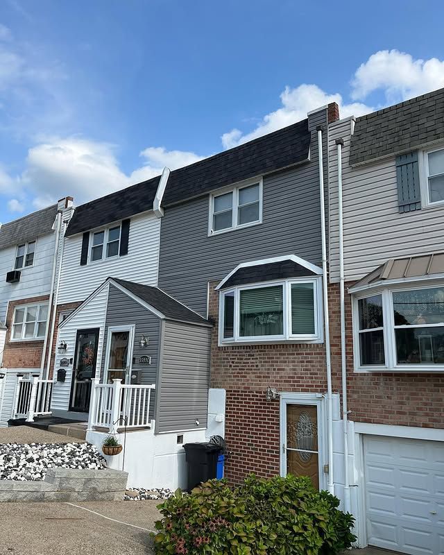 A row of houses with a blue sky in the background.