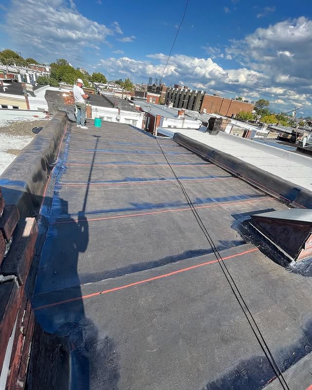 A man is standing on the roof of a building.