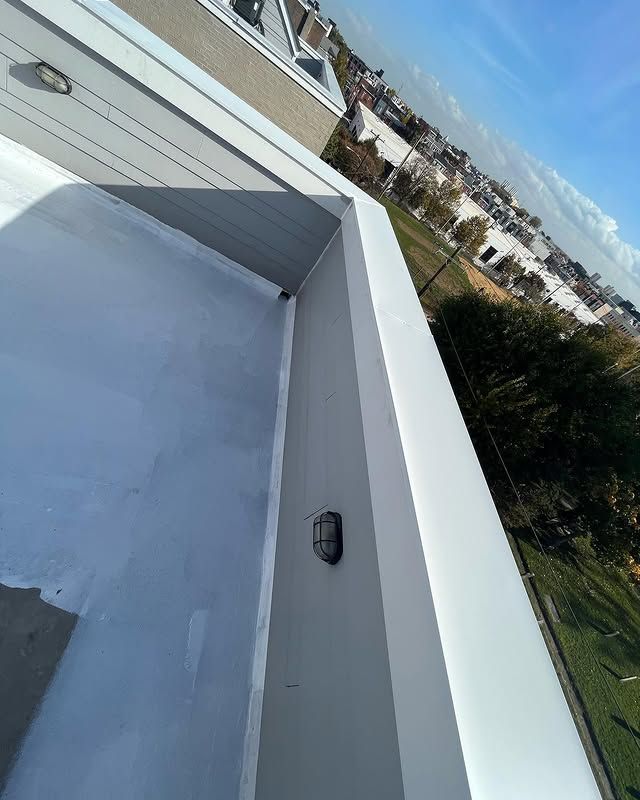 A balcony on top of a building with a view of a city.