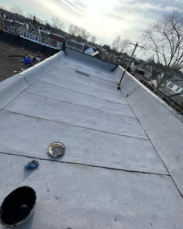A roof with a white roof and a black bowl on it.
