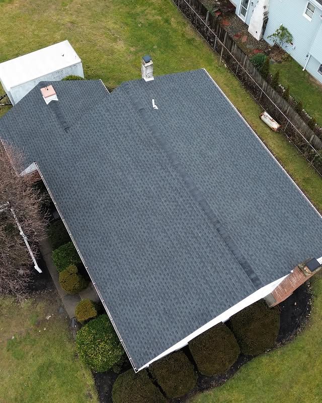 An aerial view of a house with a new roof.