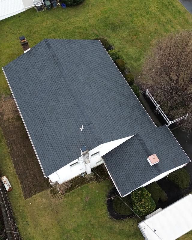 An aerial view of a house with a black roof.