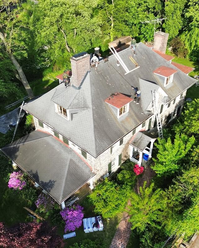 An aerial view of a large house surrounded by trees.