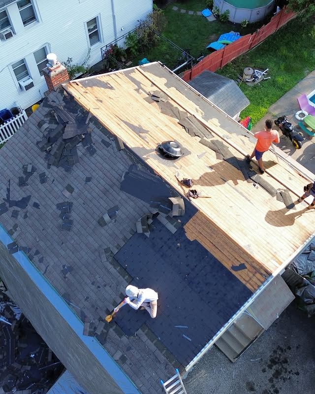 An aerial view of people working on a roof