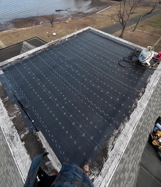 A person is standing on the roof of a building.