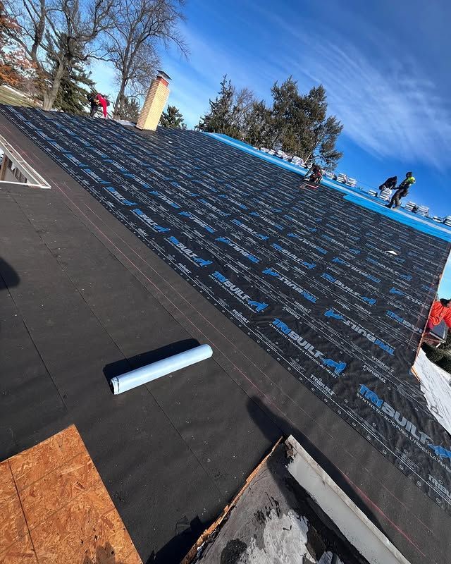 A roof with a roll of roofing material on it