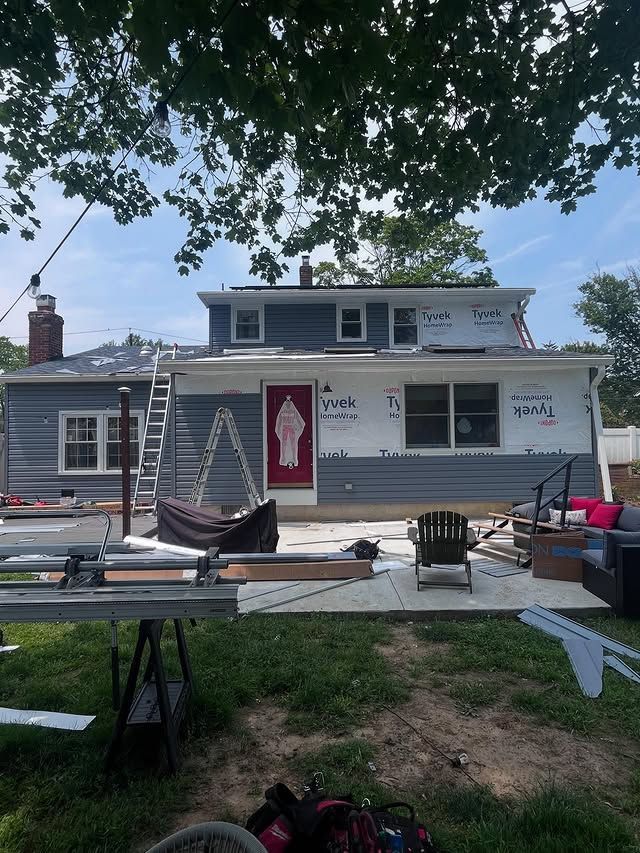A house with a red door is being remodeled.