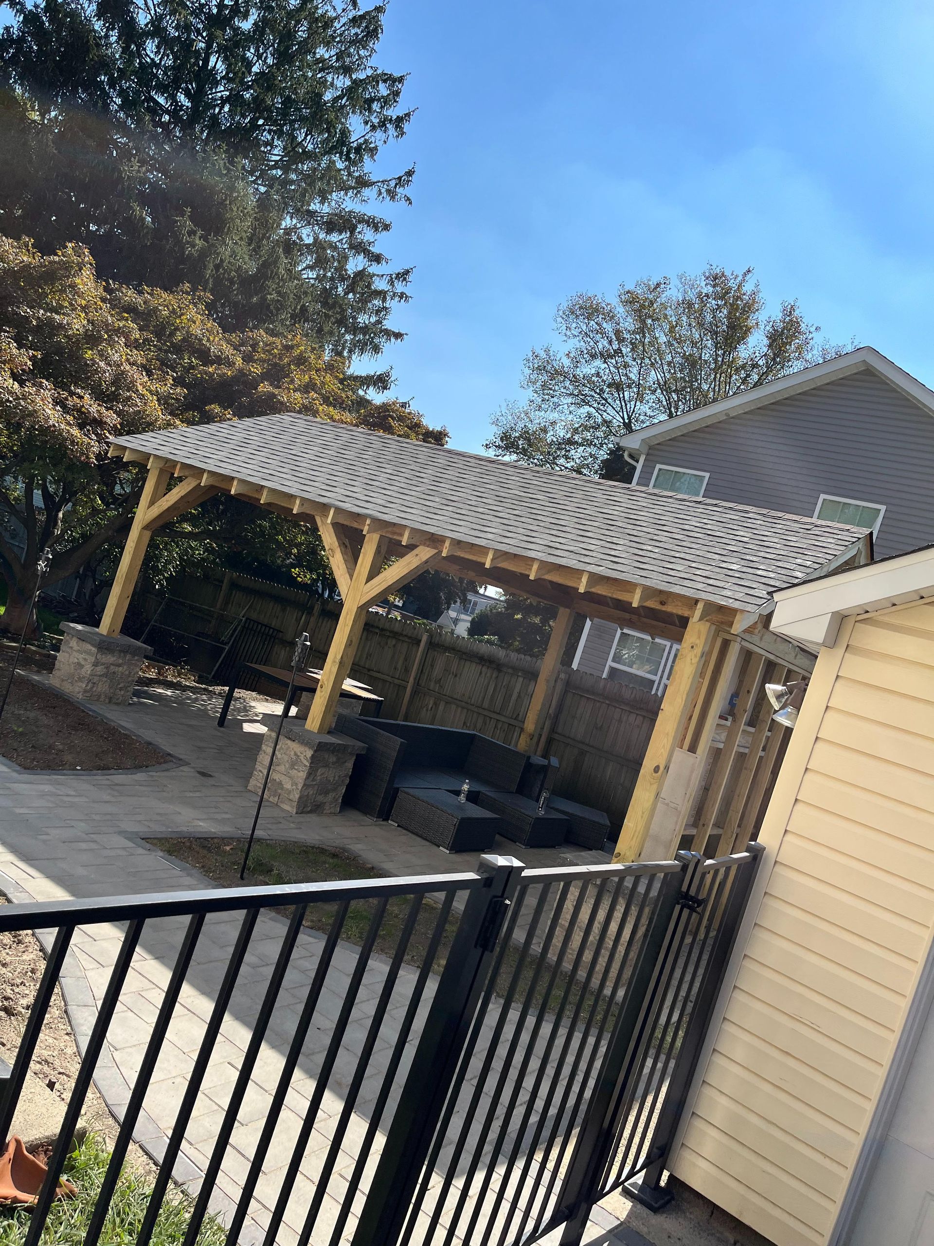 A house with a fence and a gazebo in the backyard