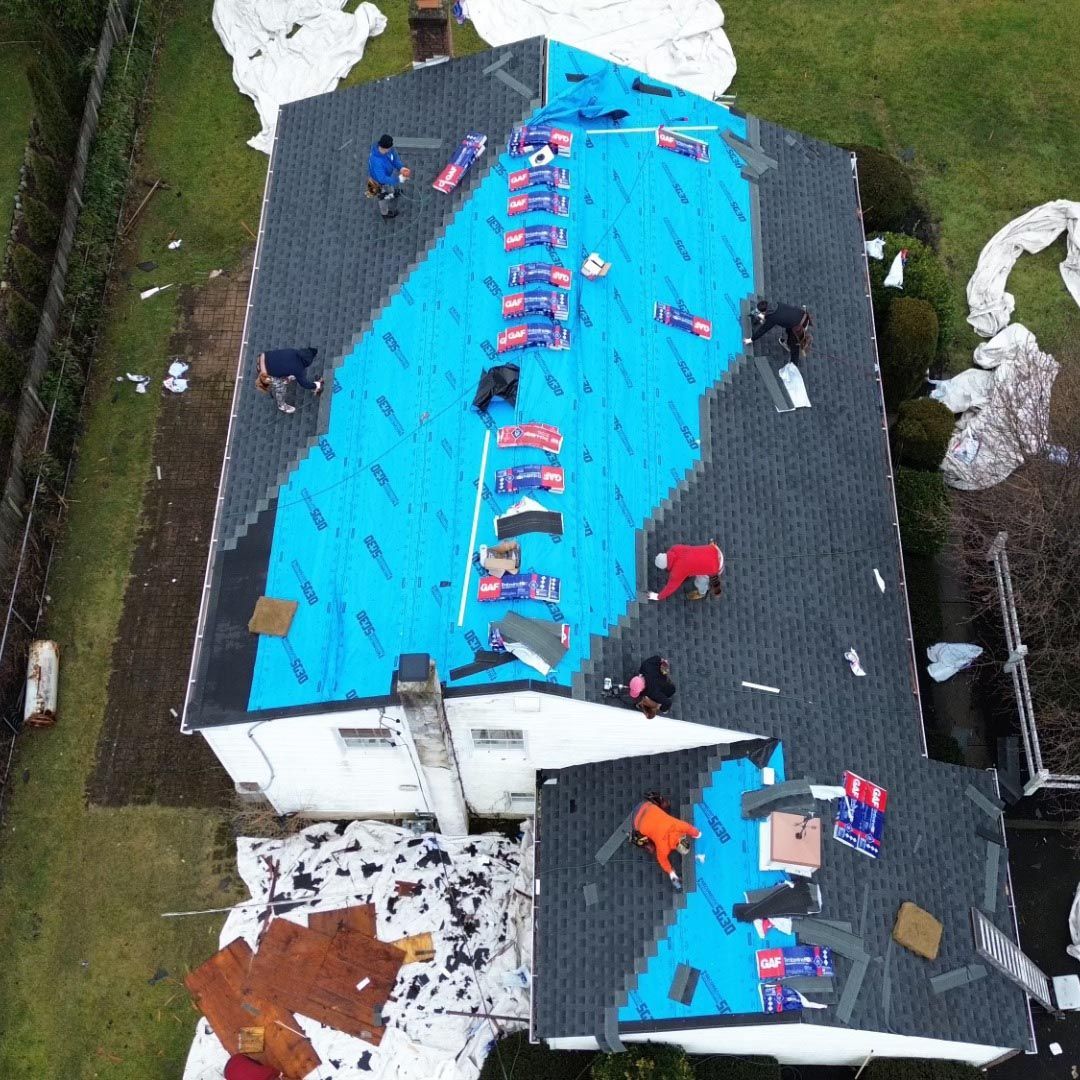 An aerial view of a roof being installed on a house