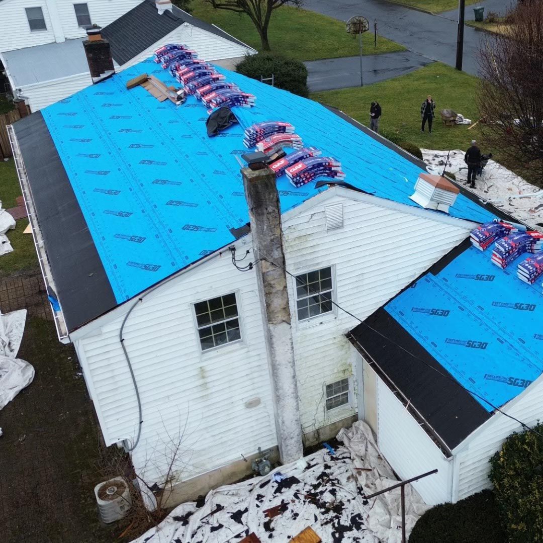 An aerial view of a house with a blue roof