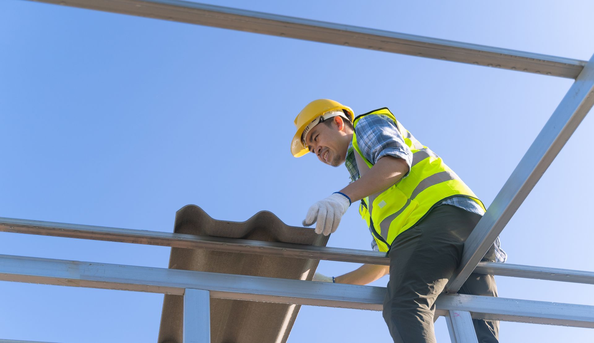 A man is installing a new roof.