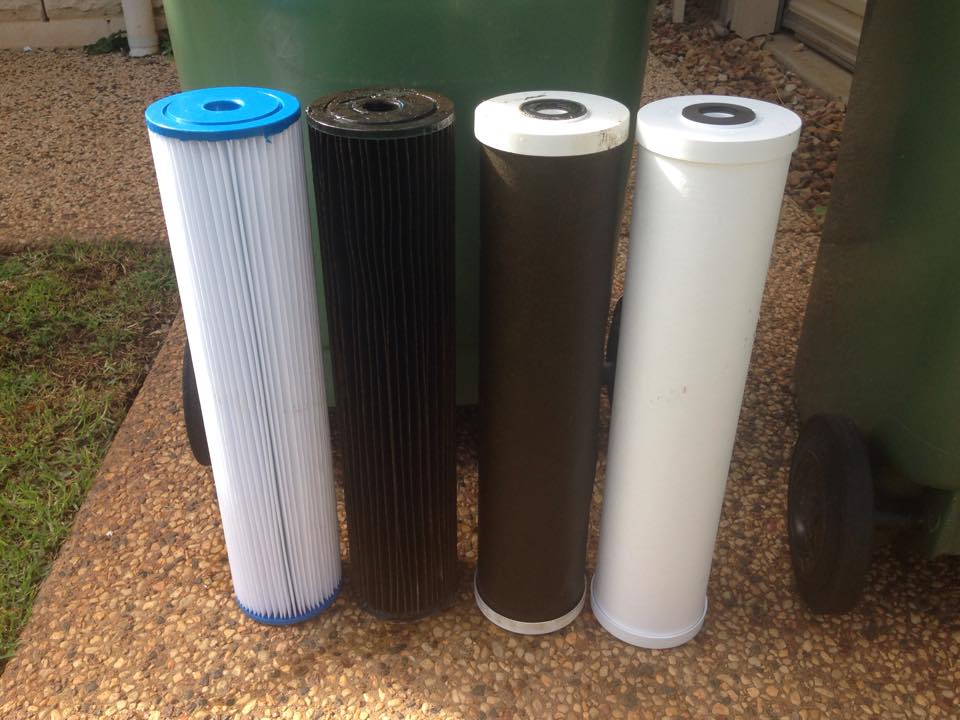 Two water filters (middle) after 12 months use (they're filthy) and two new water filters (outside) that are clean.