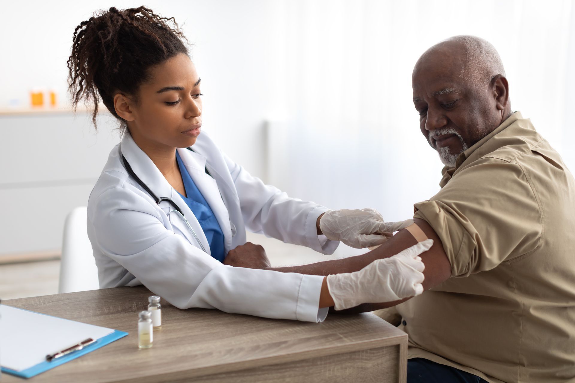 Laboratory with nurse taking a blood sample from patient