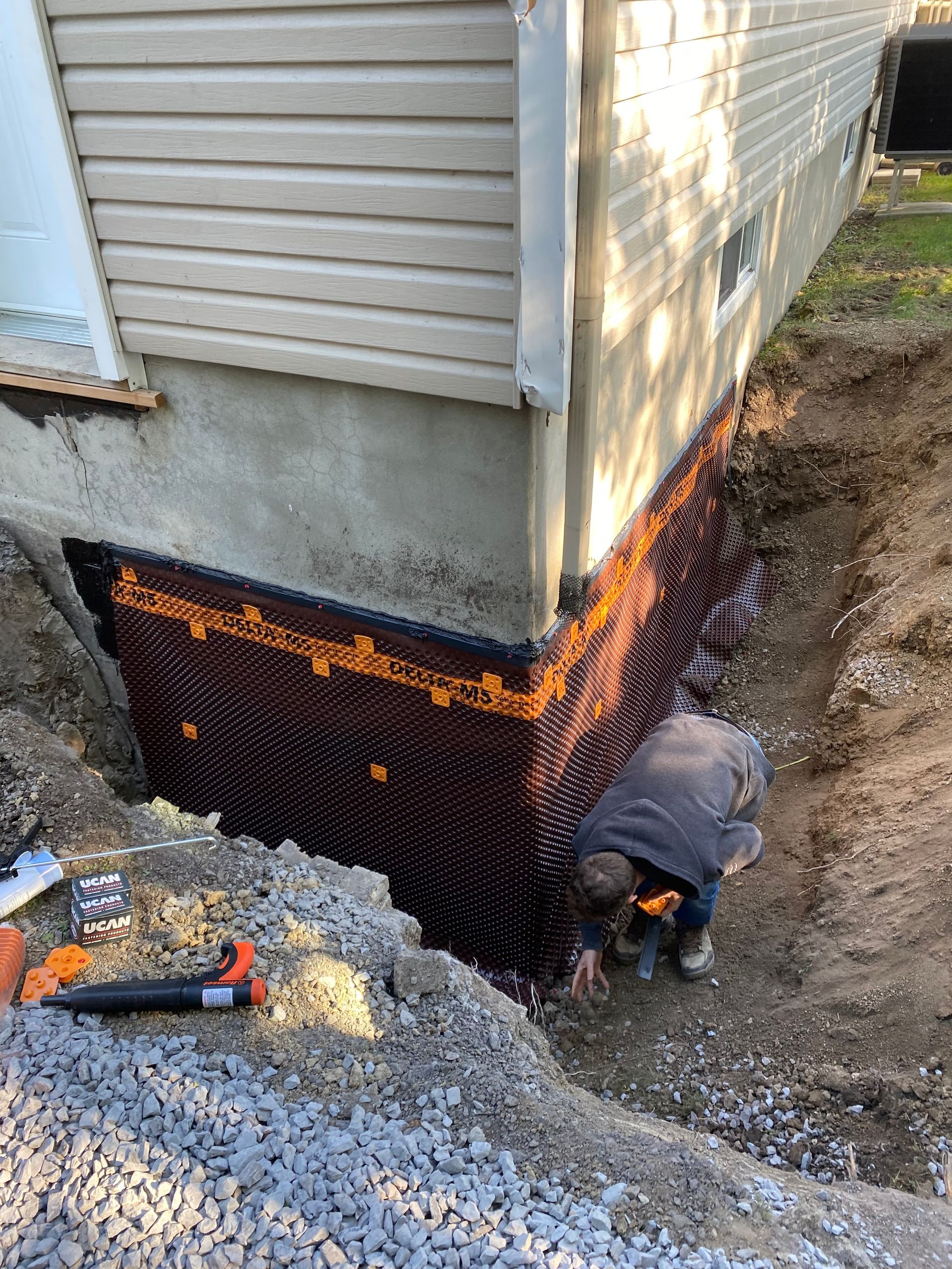 A man is working on the foundation of a house.