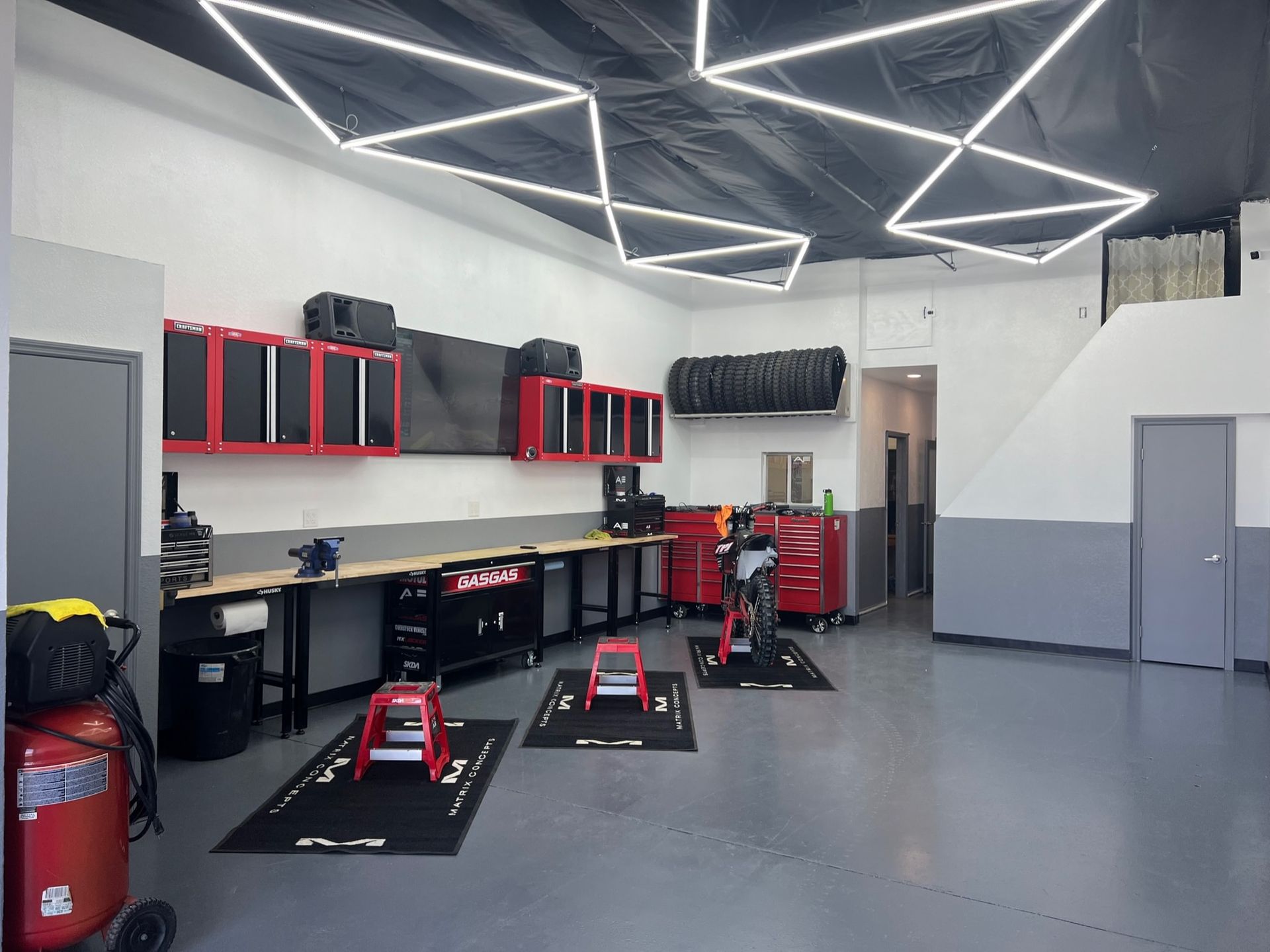 A large garage with a lot of tools and a vacuum cleaner.