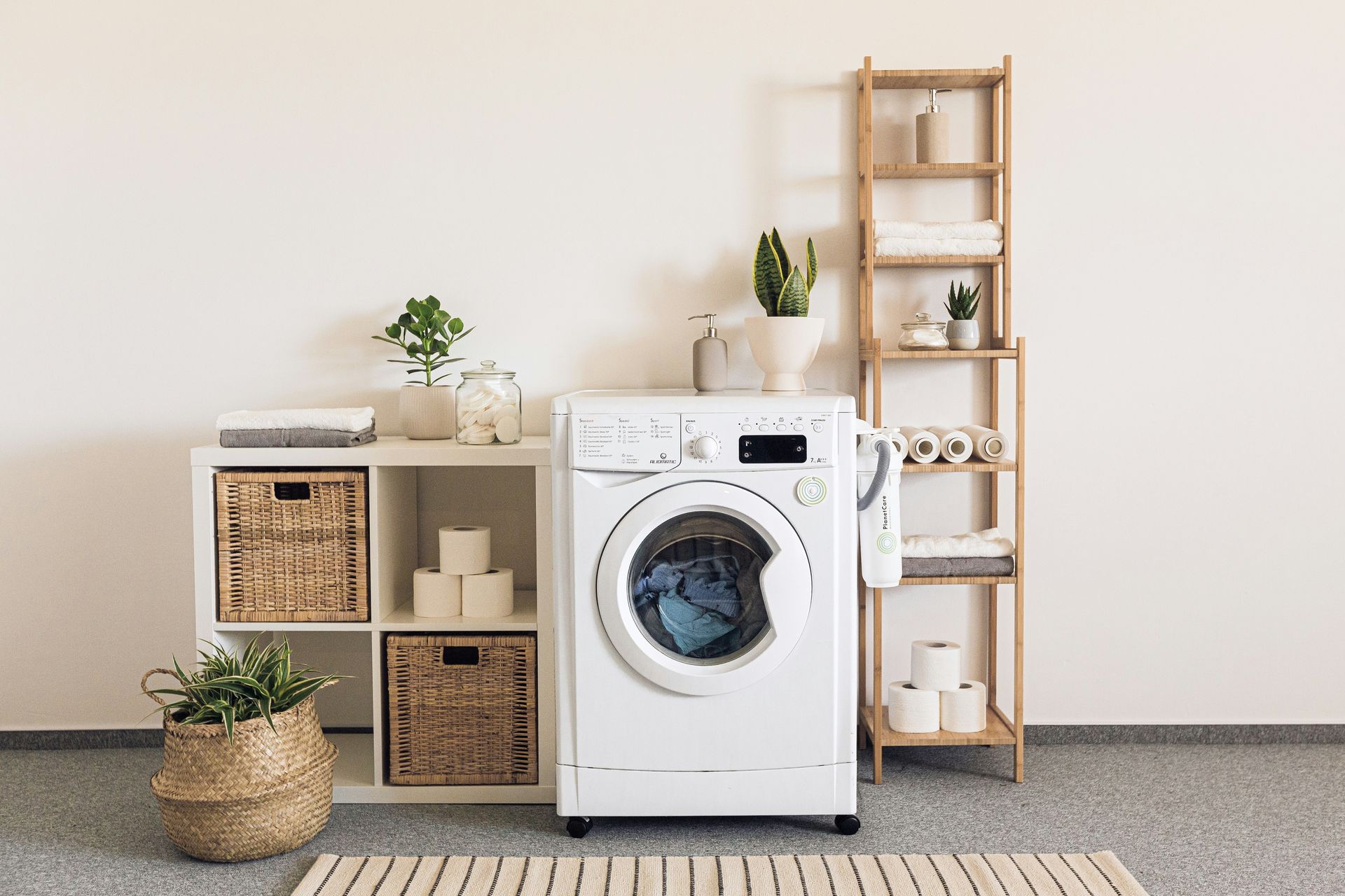 Laundry room with washer and wooden shelves