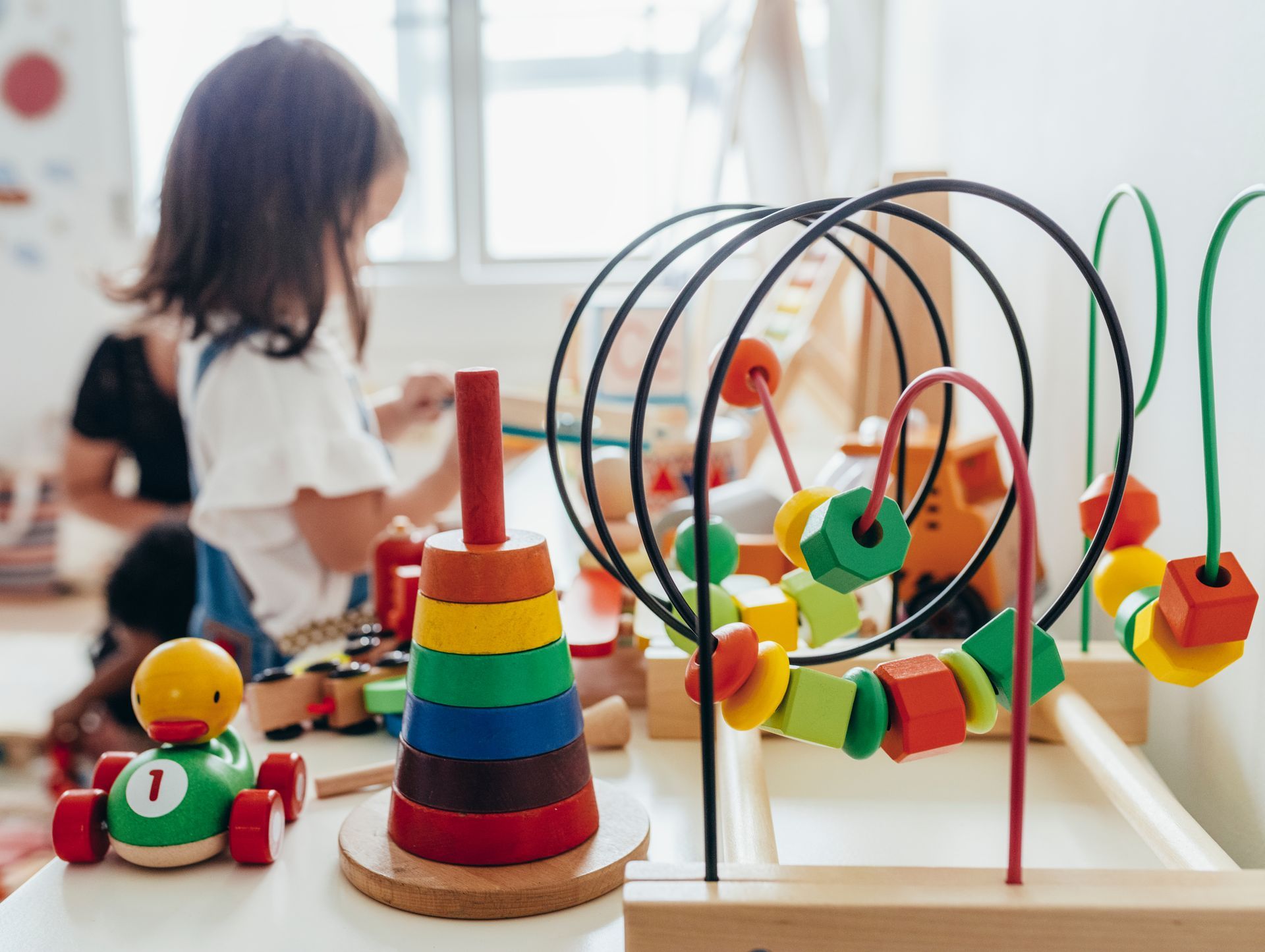 Young girl playing with educational toys.