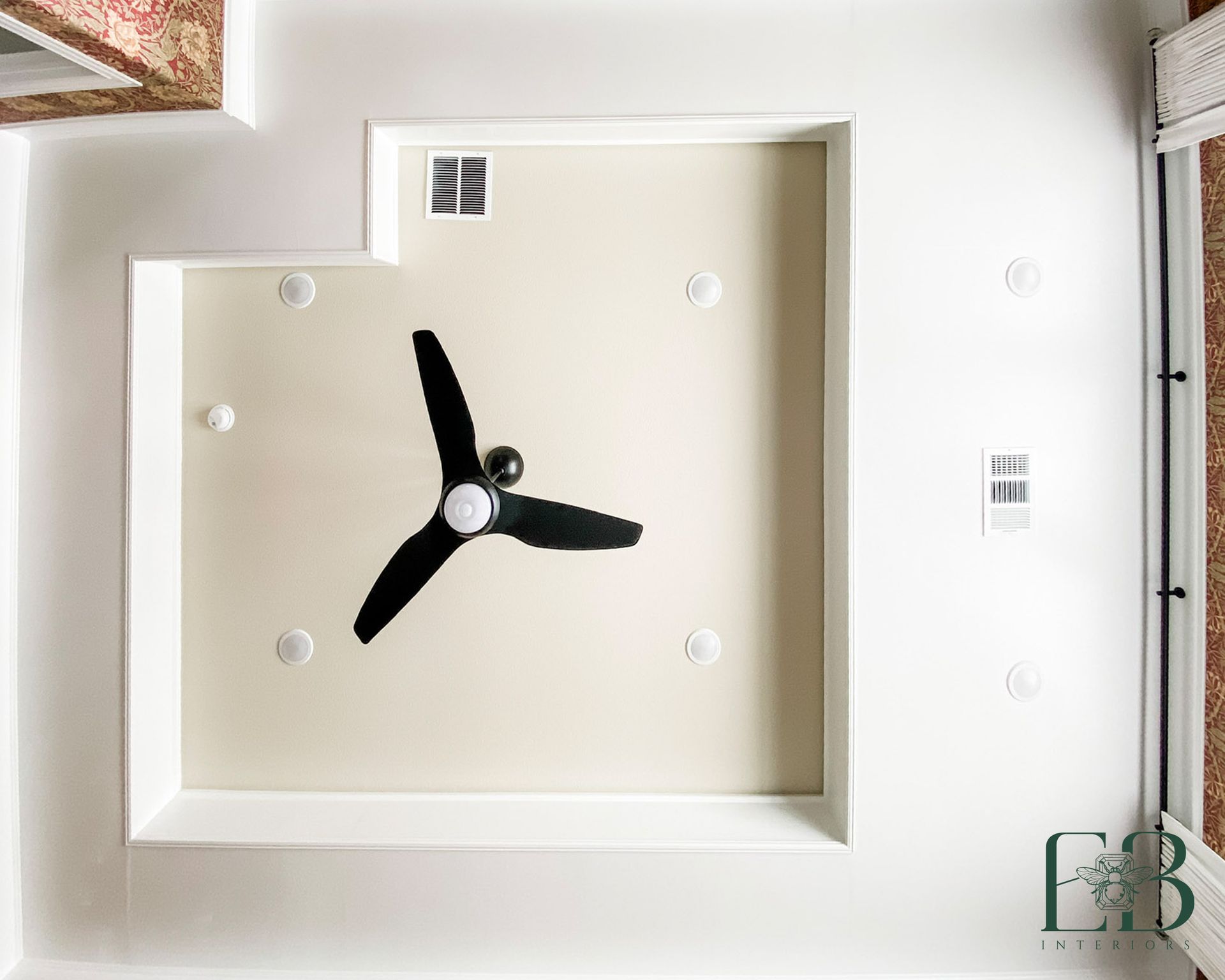 Ceiling detail in the Devotion Row primary suite with tray ceiling and black modern fan by Emerald Bee Interiors.
