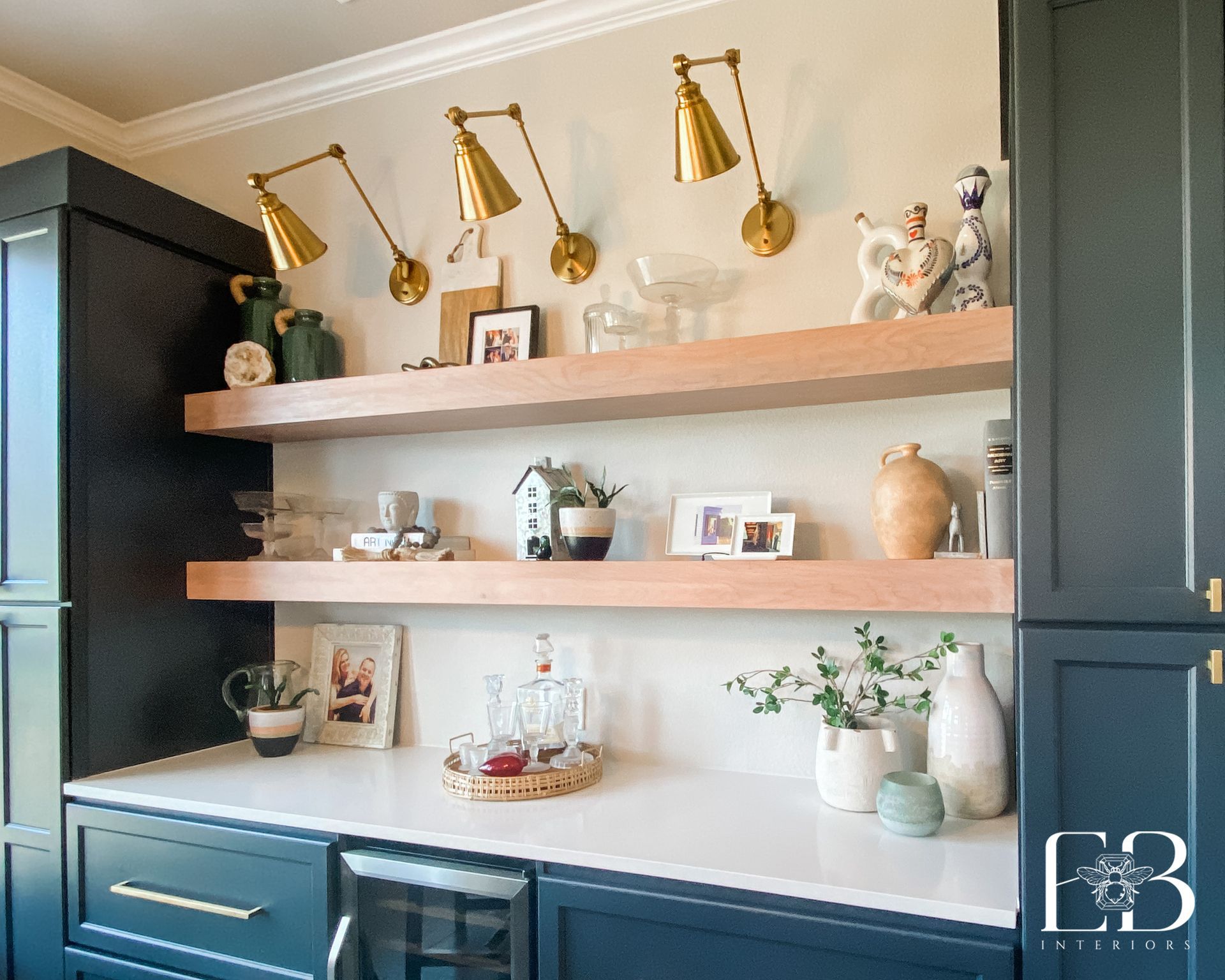 Custom shelf styling featuring layered art, sculptural objects, and natural textures—designed by Emerald Bee Interiors.