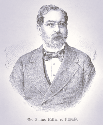 Portrait of Dr. Julius Ritter von Newald, wearing a suit and bow tie, with a full beard and glasses.