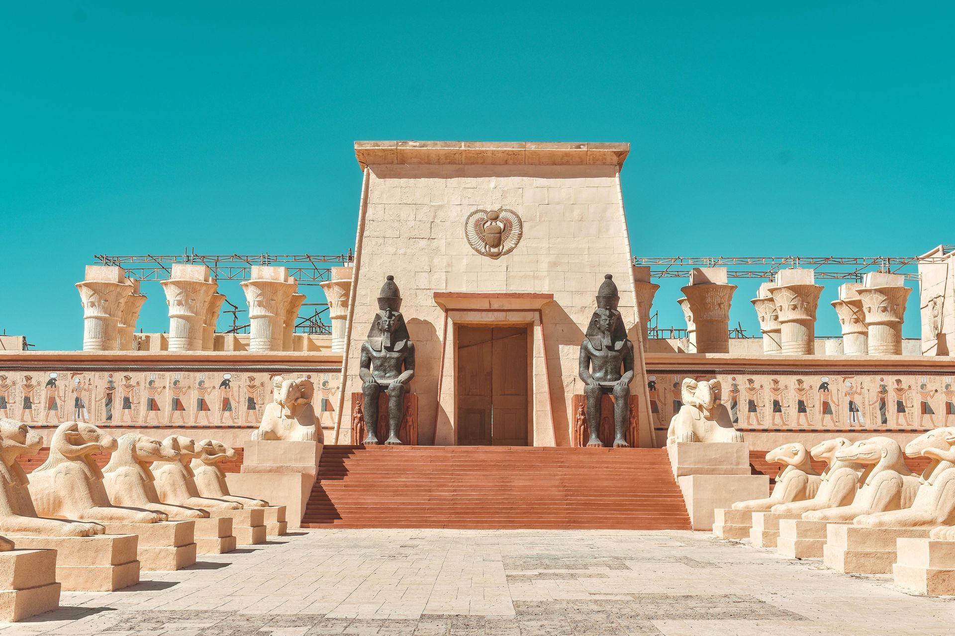 A large building with a lot of statues in front of it.