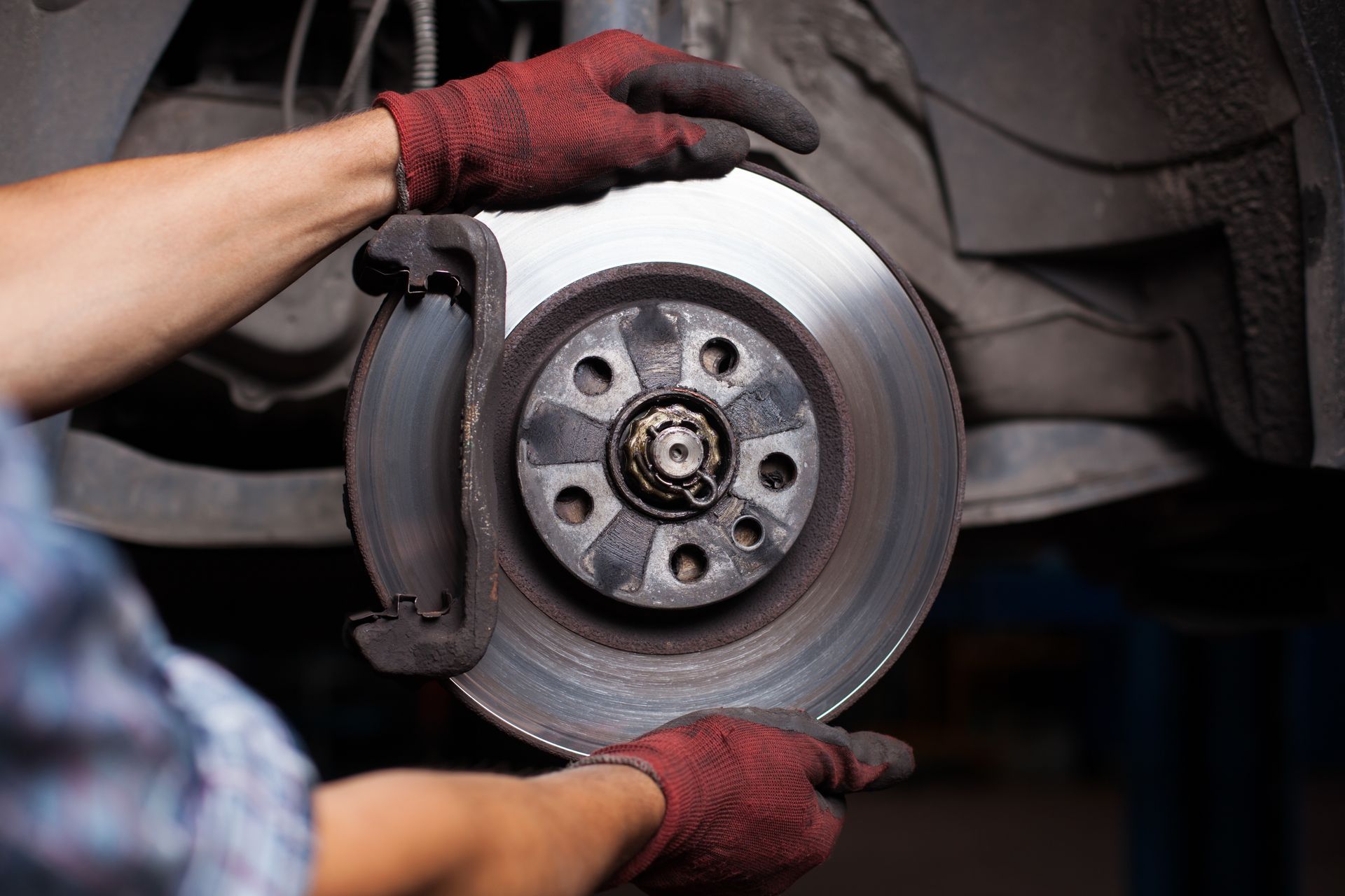 Repairing brakes on car.