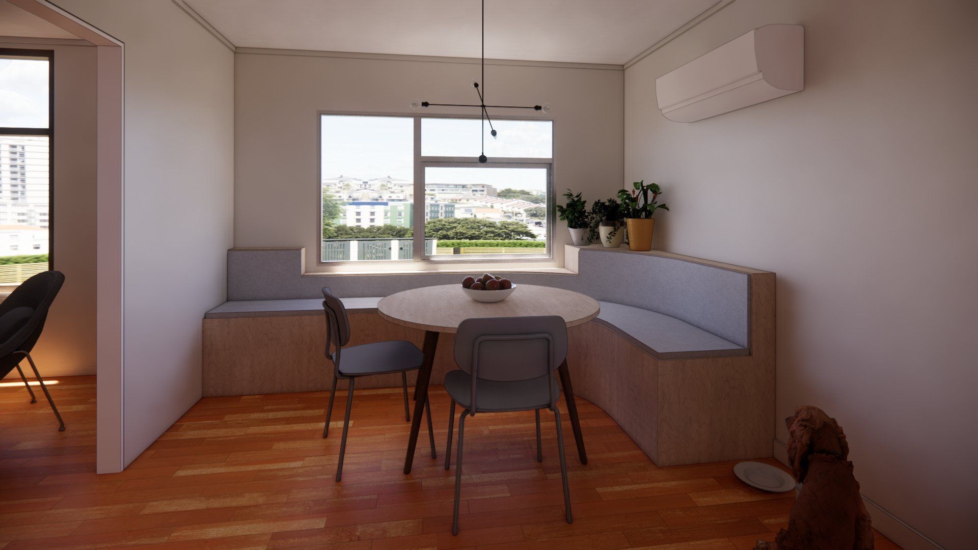 A dining room with a table and chairs in front of a window.