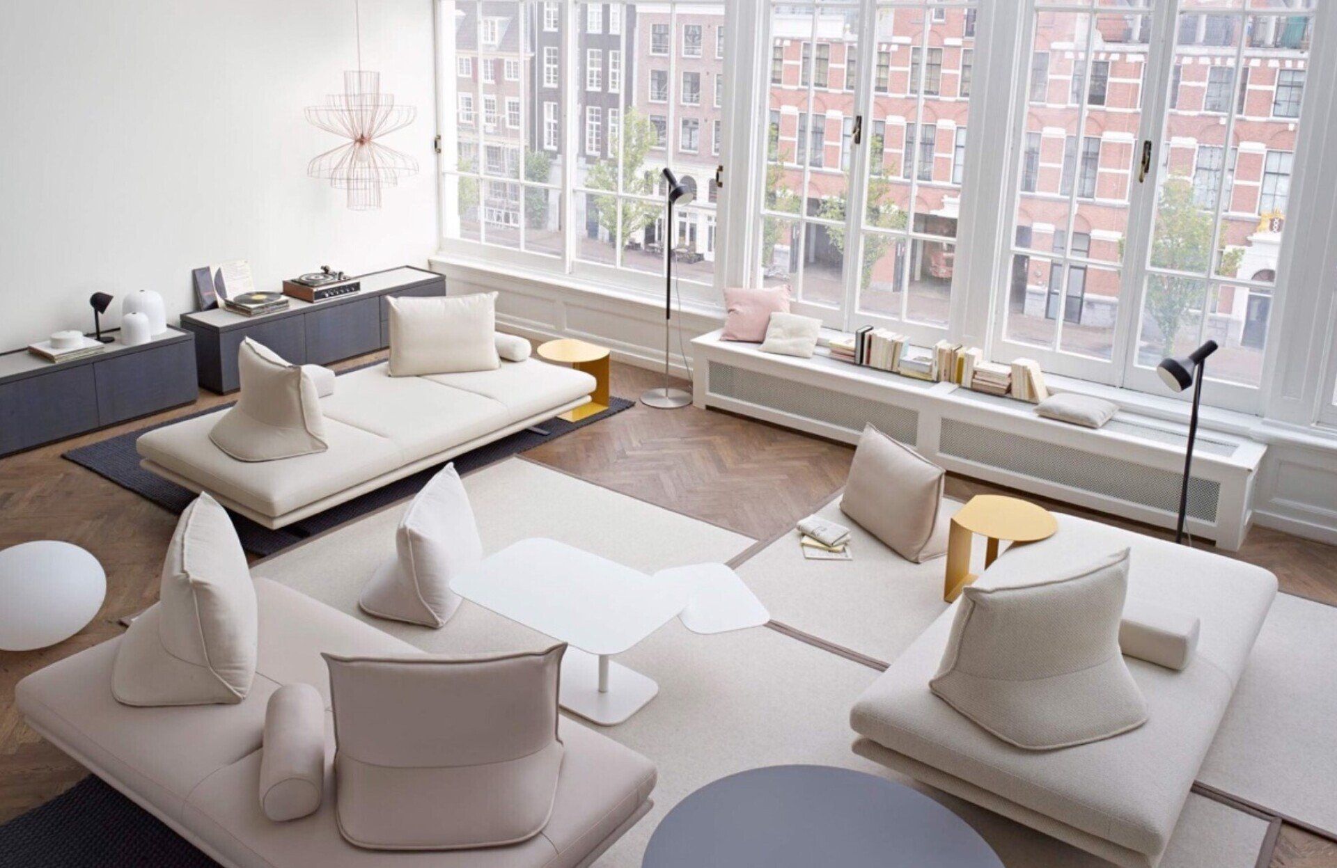 A living room with a lot of furniture and a lot of windows