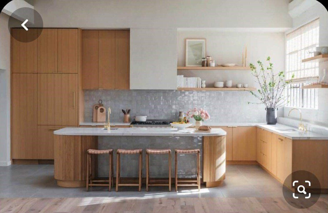 A kitchen with wooden cabinets and white counter tops