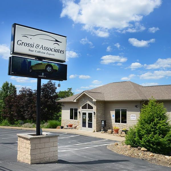 Office building with a Grossi & Associates sign under a blue sky