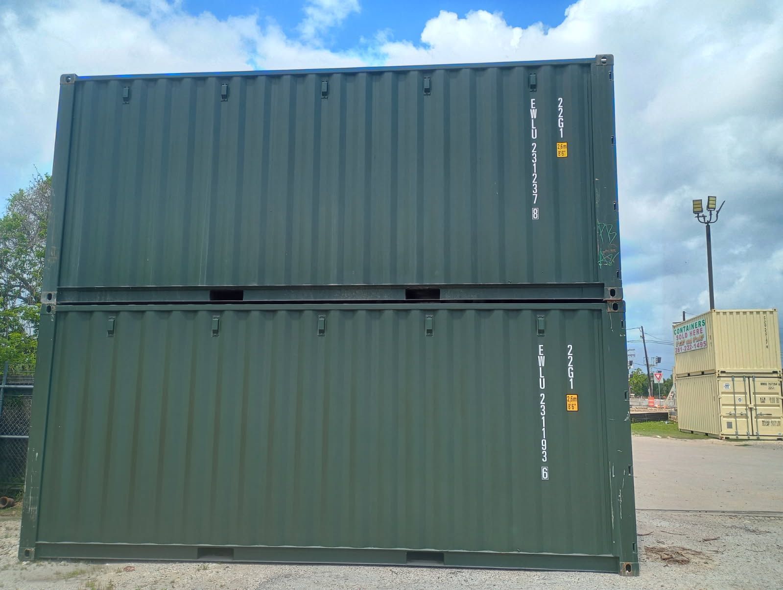 Gray shipping container doors with four latches.