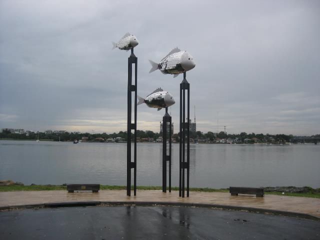 Sculpture of Metal Fish Atop Pillars Near a Body of Water — Darren Gray Cad Services In Upper Corindi, NSW