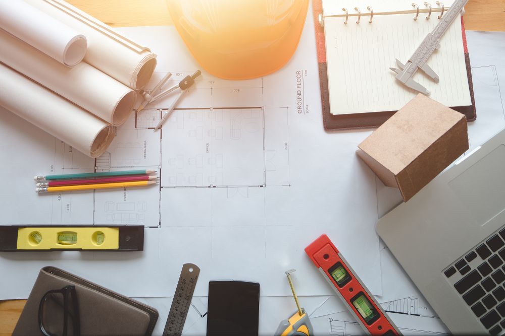 Desk With Blueprints, Tools, and Laptop — Darren Gray Cad Services In Upper Corindi, NSW