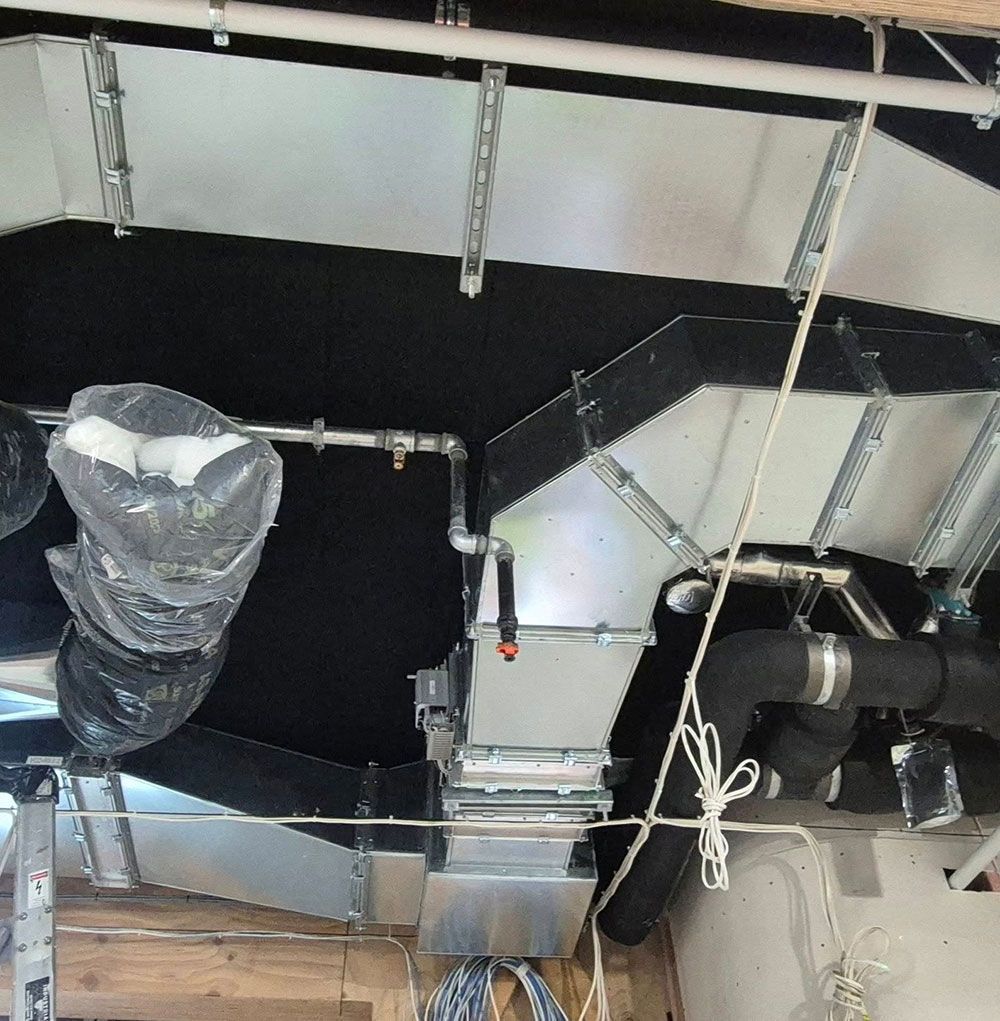 HVAC ductwork installation in a building; silver metal ducts