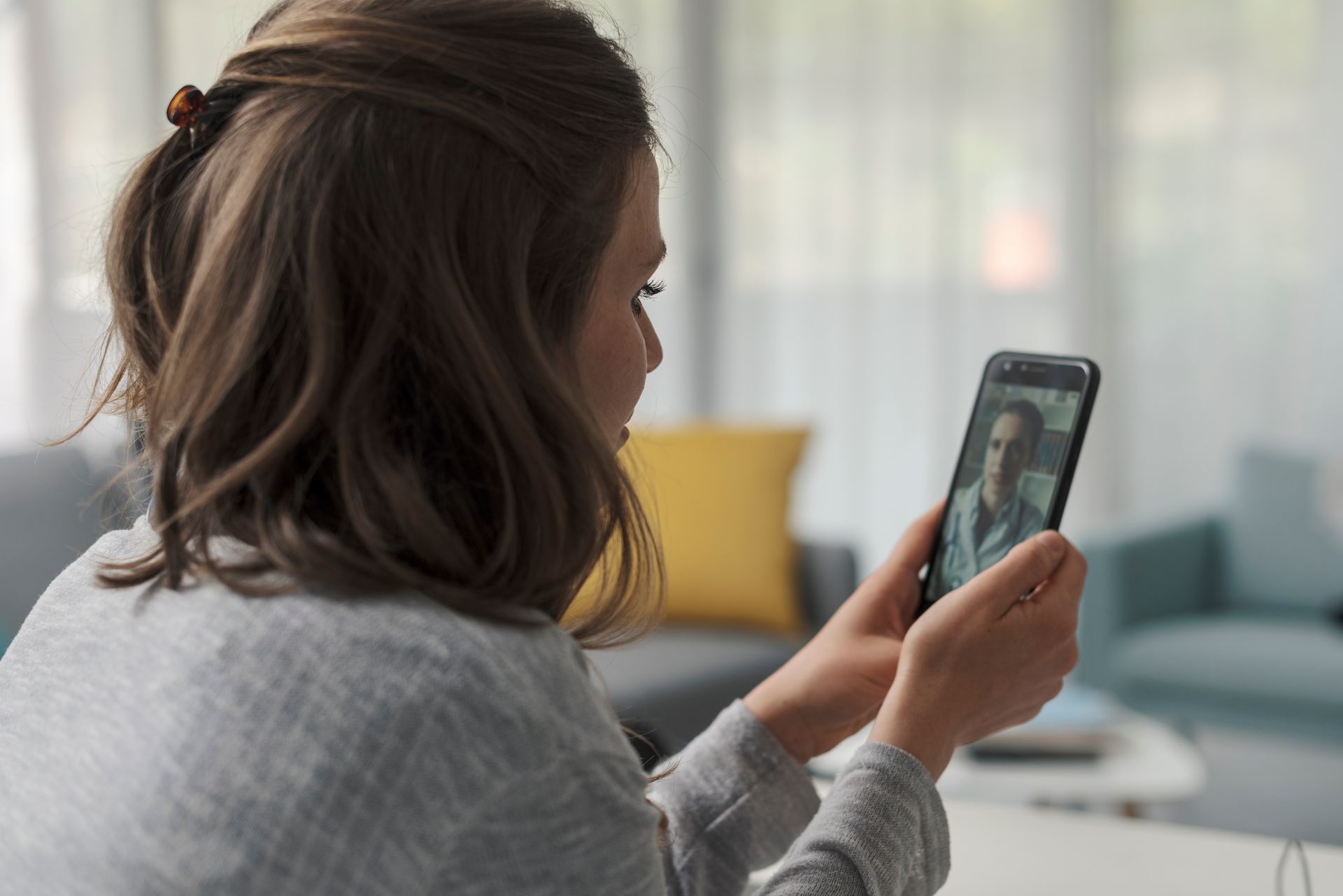 woman seeing healthcare provider online for mental health therapy