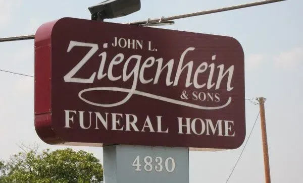 Sign for John L. Ziegenhein & Sons Funeral Home on a maroon background, with address 4830